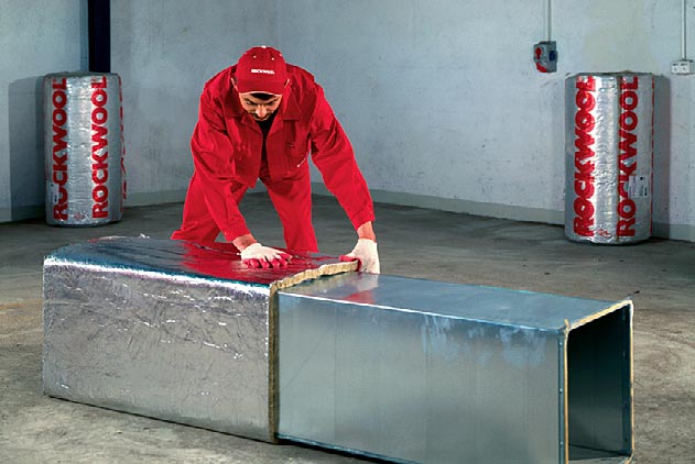 Fot. 5. Najpowszechniejszą metodą mocowania płyt i mat do kanałów wentylacyjnych jest ich klejenie bezpośrednio na powierzchnię przewodów. Warunkiem jest, by powierzchnia była sucha, czysta i odtłuszczona. W zdecydowanej większości materiały izolacyjne oferowane są z gotową warstwą kleju, która upraszcza montaż do minimum. Izolacja kanałów wentylacyjnych. Fot. ROCKWOOL